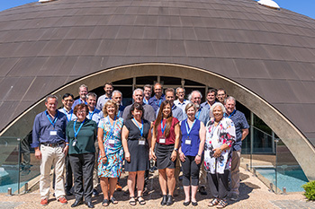 Twenty-six experts stand in front of the Shine Dome, Canberra.